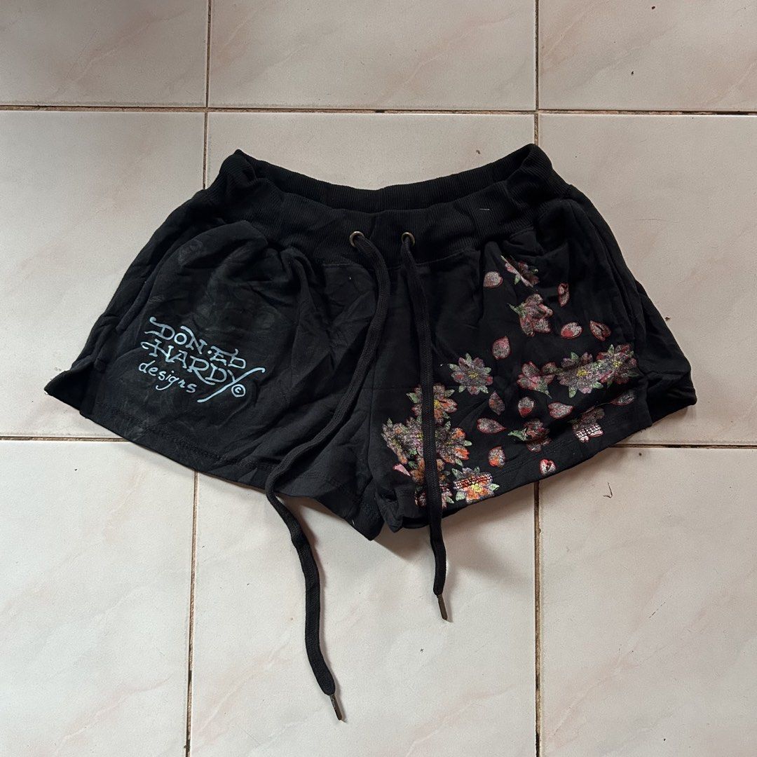 Ed Hardy Black Shorts with Graphic Print (Category: Shorts) located in Jinoba-an. Submitted by eegiboy (Listing ID 1464656643, Image 2). Description: - Black Ed Hardy shorts - Iconic Ed Hardy eagle graphic on the back - Floral design and logo on the front - Elastic waistband with drawstring - Comfortable and stylish - Perfect for casual wear for women size: 28-32 stretch l-12 Excellent condition 600plussf Dm me if interested thankyou.