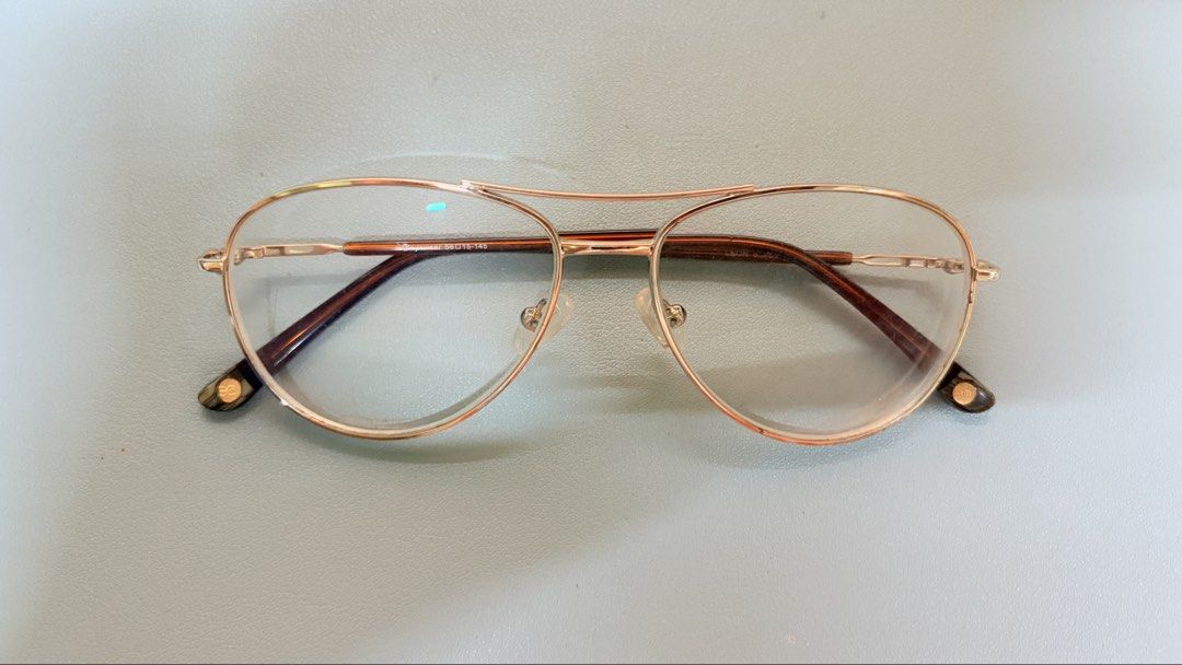 EO Eyewear Leon Eyeglasses s.j.gold (Category: Sunglasses & Eyewear) located in Manila. Submitted by ethrifts (Listing ID 1464707142, Image 2). Description: - Brand: EO Eyewear - Model: Leon - Frame Color: S.J. Gold - Style: Aviator wire frame with double bridge design and brown temple tips - Measurements: 56 lens width, 15 bridge, 145 temple length - Lenses: Graded lenses currently installed (can be replaced at EO) - No case available - SRP: ₱2,