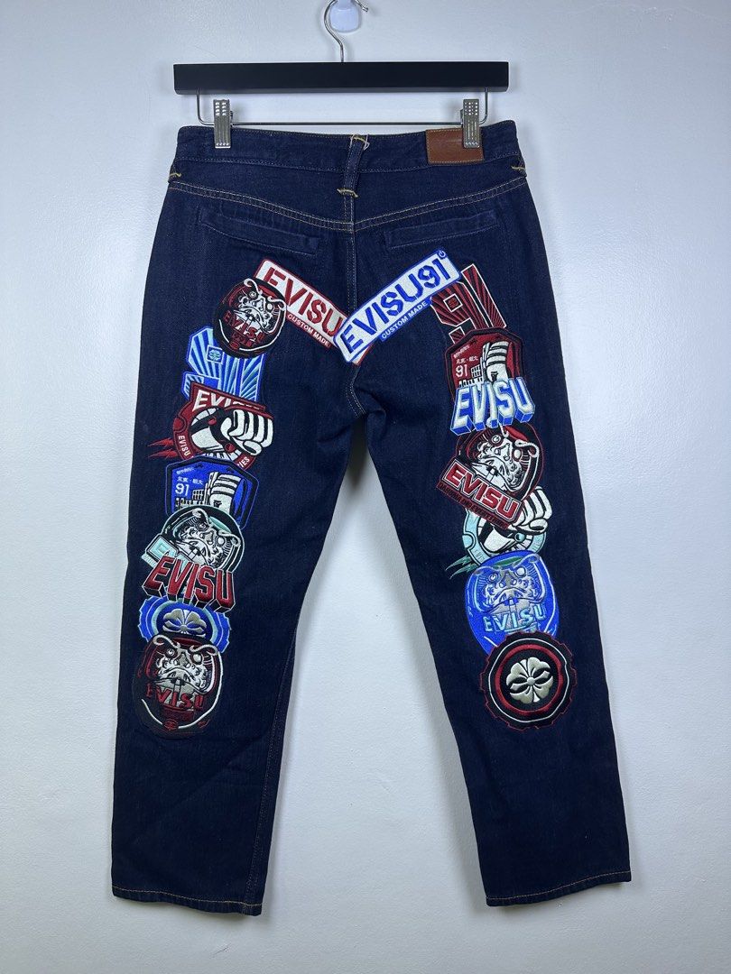 EVISU 91 Custom Made Jeans with Patches (Category: Jeans) located in Manila. Submitted by declutterpromax (Listing ID 1464617269, Image 3). Description: - Dark wash Evisu jeans - Iconic Evisu logo patches all over - Button fly closure - Leather patch on the back - Size: 28x34 - A great statement piece.