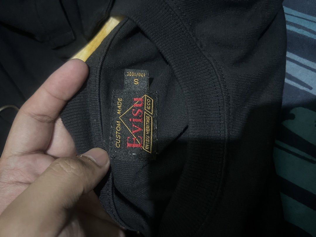 EVISU Black T-Shirt Size S (Category: Tshirts & Polo Shirts ) located in Manila. Submitted by dwyaneallen (Listing ID 1464580429, Image 3). Description: - Authentic Black Evisu T-shirt - Features multiple Evisu logos on the front - Includes a stylish pocket detail - Size: Small (S) - Made in Japan - Ideal for everyday casual wear.