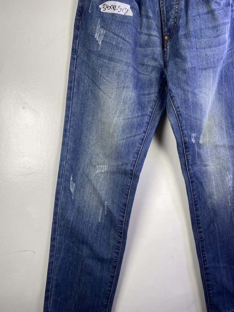 Evisu Jeans 13oz Denim Distressed Blue (Category: Jeans) located in Manila. Submitted by declutterpromax (Listing ID 1464601129, Image 2). Description: - Classic Evisu Jeans - Size: 34x32 - Material: 13oz Denim - Wash: Distressed Blue - Features: Iconic Evisu logo on back pockets, button fly closure, frayed hem detail.