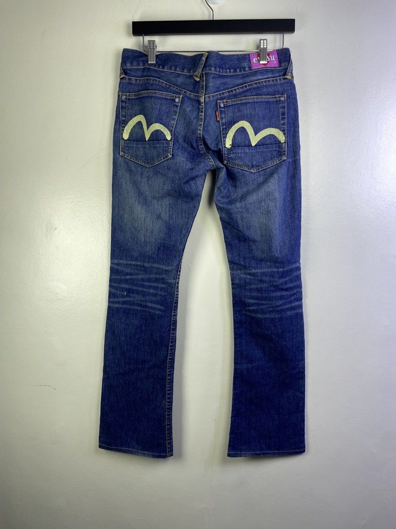 Evisu Jeans Blue Denim M Logo (Category: Jeans) located in Manila. Submitted by declutterpromax (Listing ID 1464601136, Image 2). Description: - Brand: Evisu - Type: Blue Denim Jeans - Fit: Classic Straight Leg - Signature Detail: Iconic M logo on back pockets - Condition: Good, with some signs of wear - Style: Perfect for casual wear.