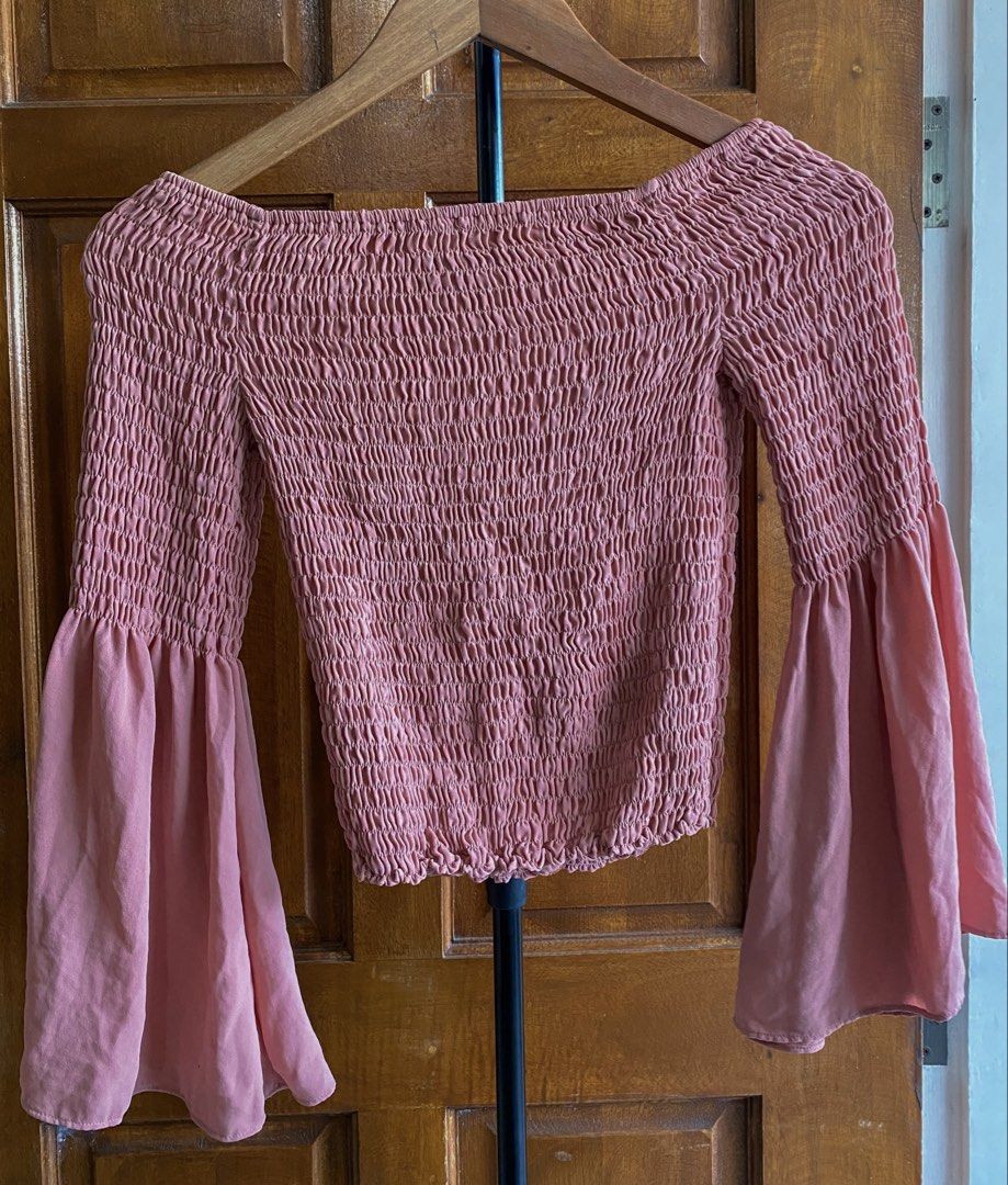 Express Smocked Off-Shoulder Bell Sleeve Top (Category: Blouses) located in Legazpi City. Submitted by engr.i (Listing ID 1464587721, Image 2). Description: - Fits XS-M - Brand: Express - Color: Pink - Style: Cropped Smocked Top - Features: Off-shoulder, Long Bell Sleeves - Design: All-over smocking on bodice and sleeves - Occasion: Dress up or down, versatile - Comfort: Easy to wear and comfortable.