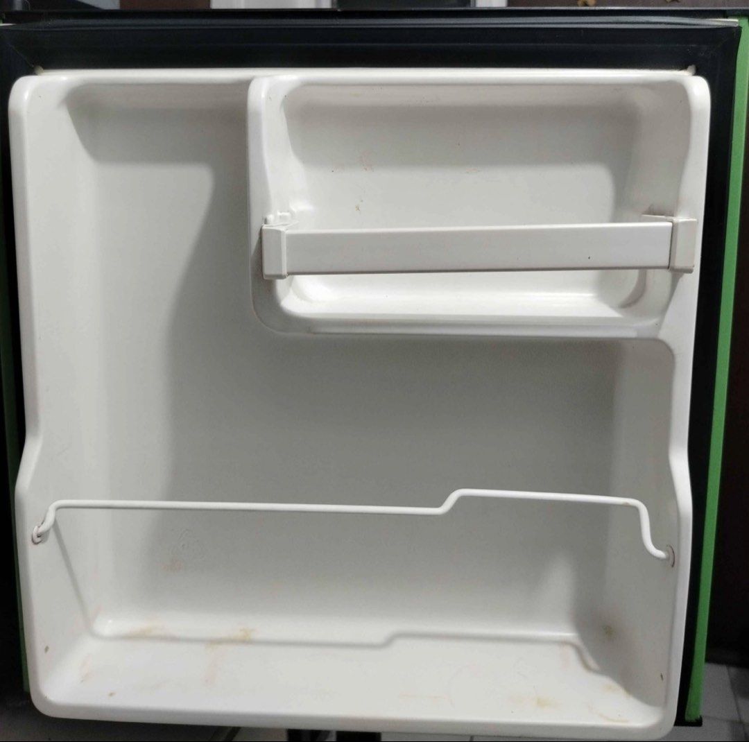 EZY Mini Fridge Green (Category: Refrigerators and Freezers) located in Batangas. Submitted by shibriones (Listing ID 1464589486, Image 2). Description: - Compact mini fridge in a cute green color - Ideal for dorm rooms, bedrooms, or office spaces - Fully functional and works well - Includes an interior shelf and a top compartment - Door offers convenient storage for small items - Interior is clean and well-maintained - Minor cosmetic scuffs on t