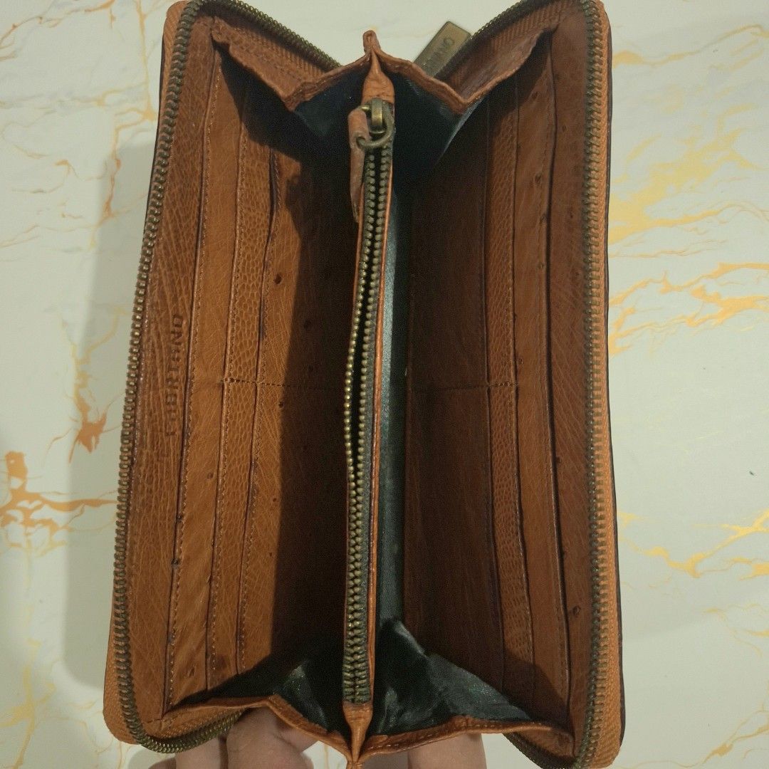 Fabriano Brown Leather Zip Around Long Wallet (Category: Wallets & Card holders) located in Baguio. Submitted by marjshane11317 (Listing ID 1464734943, Image 3). Description: - Brand: Fabriano - Material: Brown textured ostrich leather - Closure: Secure zip-around - Interior: Multiple card slots, slip pockets, and a center zippered coin compartment - Size: Approximately 19 cm across - Condition: Normal wear on leather and hardware; all zippers ru