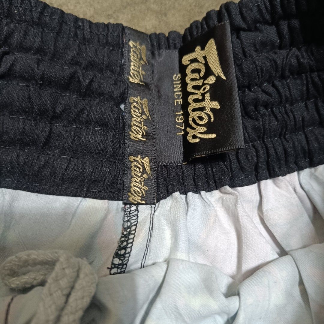 Fairtex x Urface (Category: Activewear) located in Angeles City. Submitted by thriftilious.ph (Listing ID 1464715828, Image 2). Description: - Brand: Fairtex x Urface collaboration - Design: Vibrant multi-color graffiti and pop art graphics with black carbon-fiber side panels - Size: Large - Fit: Elastic waistband with adjustable drawstring - Origin: Made in Thailand - Care Instructions: Hand wash only, do not tumble dry - Details: Iconic Fairtex