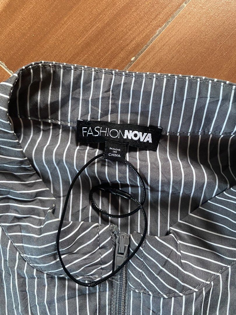 Fashion Nova Striped Zip-Up Jacket (Category: Coats, Jackets and Outerwear) located in Manila. Submitted by reginemarquez412 (Listing ID 1464673414, Image 2). Description: - Fashion Nova grey and white pinstripe jacket - Zip-up front with stand-up collar - Long sleeves with flared cuffs - Fitted waist - Versatile for layering or wearing solo.