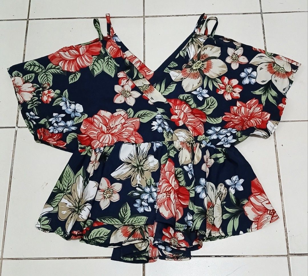 Floral Cold Shoulder V-Neck Peplum Blouse (Category: Blouses) located in Las Pinas. Submitted by anna_katrina (Listing ID 1464749211, Image 1). Description: - Color & Pattern: Navy blue with a bold, all-over floral print - Design: V-neckline with trendy cold shoulder straps and short, flowy sleeves - Silhouette: Flattering peplum waist with a stylish layered ruffle hem - Material: Lightweight, breathable fabric that's super comfy for daily wear -
