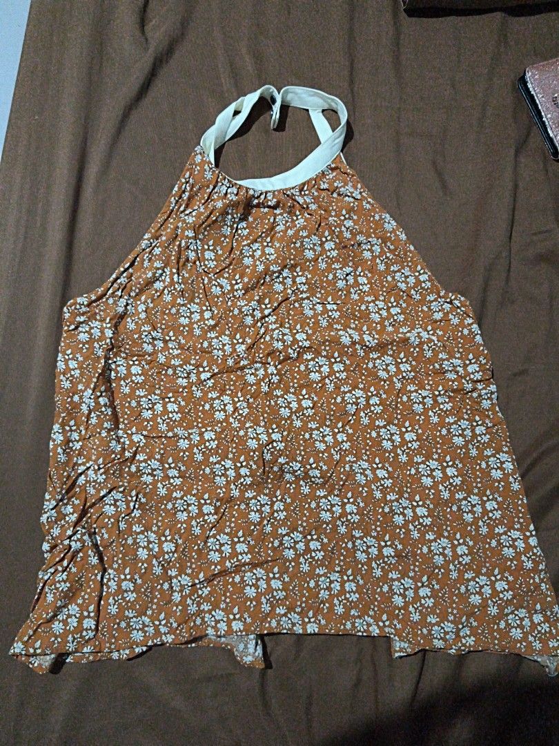 Floral Halter Neck Romper (Category: Rompers) located in Manila. Submitted by xoesnup1 (Listing ID 1464736844, Image 1). Description: - Brand: Intermax - Style: Brown romper with all-over white floral print - Details: Halter neck with white straps, front button-down closure - Material: Lightweight and breathable - Condition: Excellent / Like new - Perfect for: Casual day outs, beach trips, and warm weather.