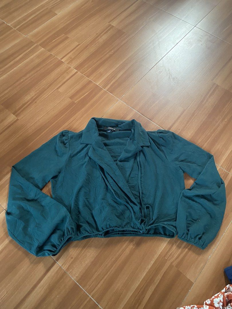 Forever 21 Contemporary Teal Wrap Crop Top (Category: Blouses) located in Manila. Submitted by reginemarquez412 (Listing ID 1464673945, Image 1). Description: - Teal wrap crop top from Forever 21 Contemporary - Long sleeves with cinched cuffs - Adjustable tie closure at the waist - Textured fabric for a unique feel - Perfect for dressing up or down.