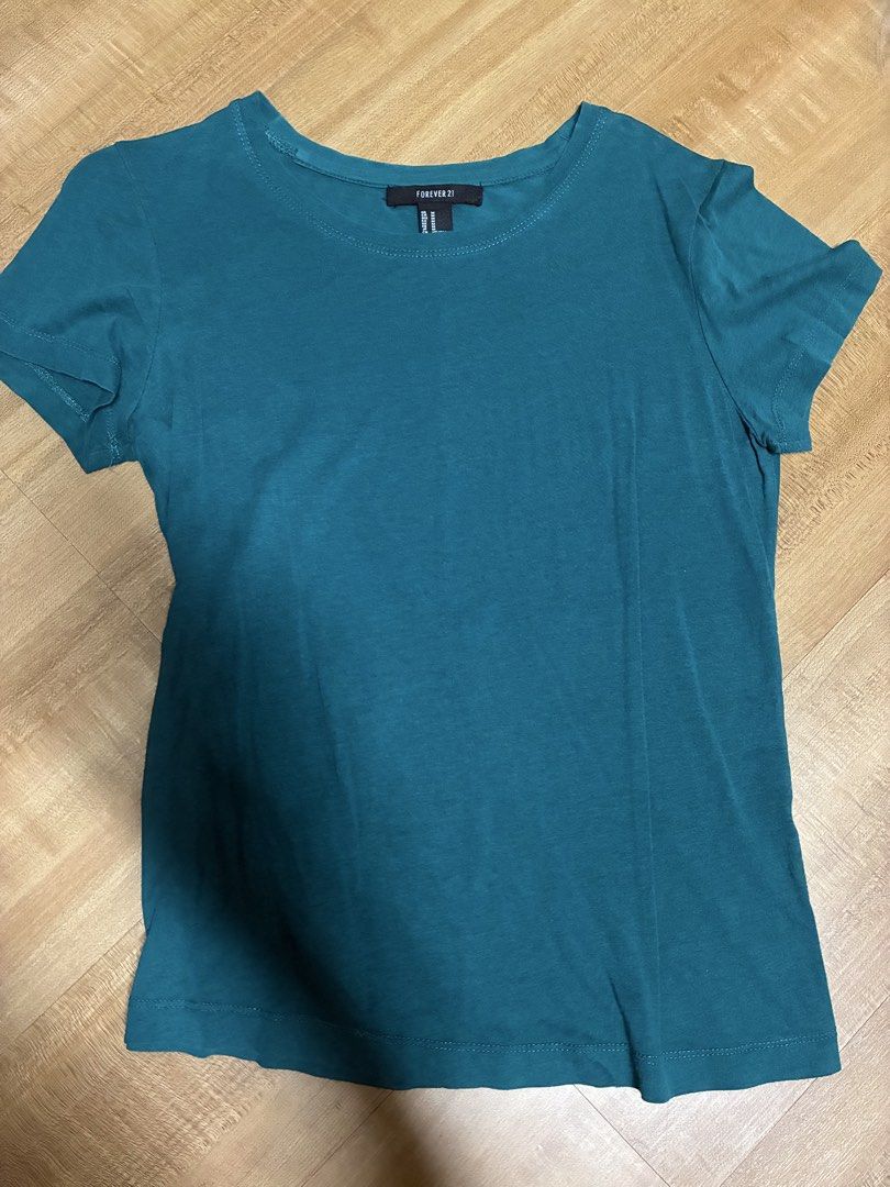 Forever 21 Teal blue green basic T-Shirt (Category: Shirts) located in Quezon City. Submitted by habits.mnl (Listing ID 1464680103, Image 1). Description: - Basic teal t-shirt - Brand: Forever 21 - Style: Short sleeves, crew neck - Material: Soft fabric - Versatility: Great for everyday wear, layering, or pairing with jeans/shorts.
