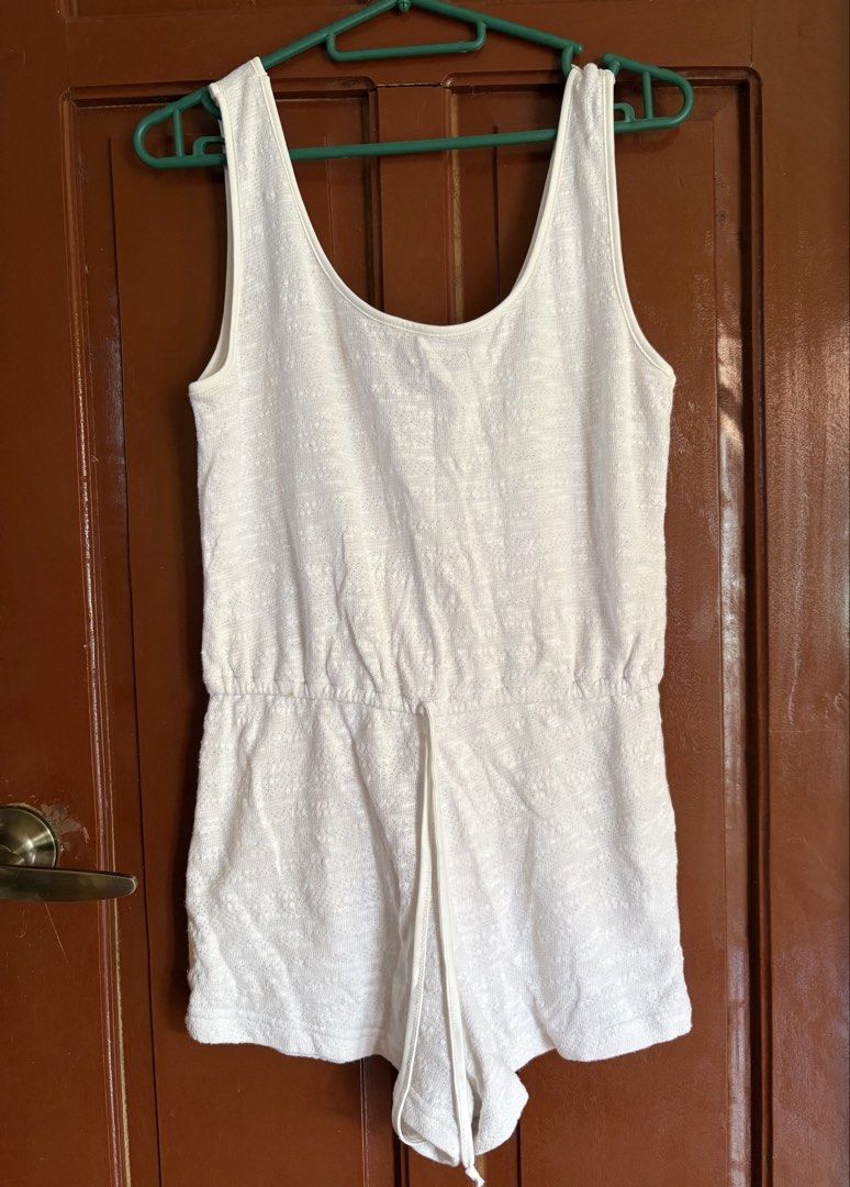 Forever 21 White Textured Drawstring Romper (Category: Rompers) located in Lucban. Submitted by paulapicks (Listing ID 1464634580, Image 1). Description: - White textured romper from Forever 21 - Features a drawstring waist for adjustable fit - Flattering scoop neckline - Sleeveless design, ideal for warm weather - Versatile for casual wear or beach days - Effortless to style for any occasion.
