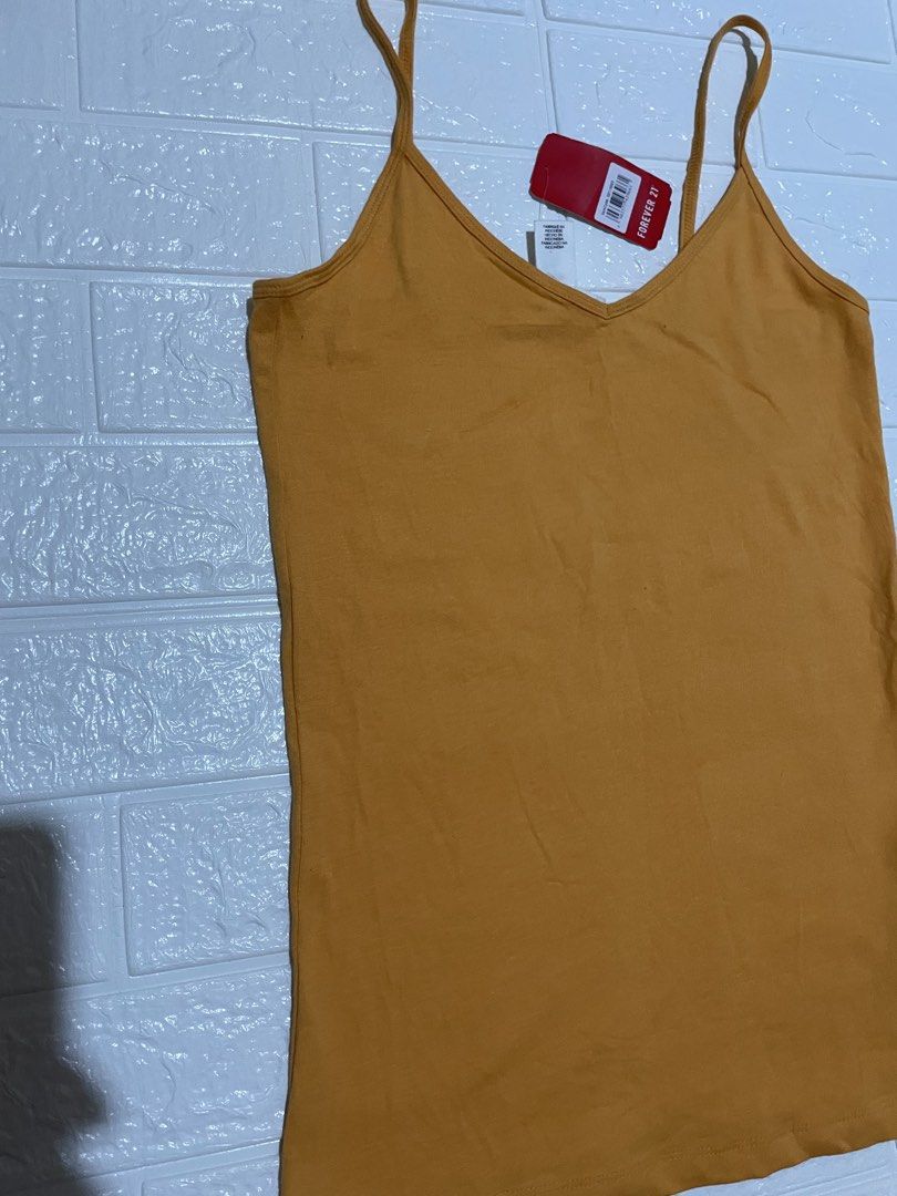 Forever 21 Women's Basic Camisole Top (Category: Sleeveless) located in Marilao. Submitted by clear_out_closet (Listing ID 1464630106, Image 2). Description: Item Details: 👇 • Brand: Forever 21 • Color: Aspen Gold / Mustard Yellow • Country of Origin: Made in Indonesia • Sizing: US M / CA M / MX M / EU M / UK M / JP M / KR M / CN 165/92A • Condition Note: Brand new with tags in pristine condition featuring thin spaghetti straps, a classic V-neck