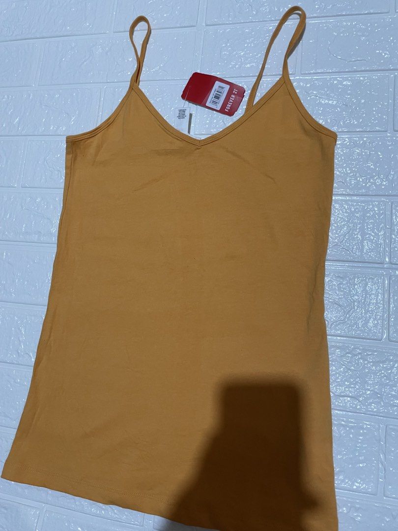 Forever 21 Women's Basic Camisole Top (Category: Sleeveless) located in Marilao. Submitted by clear_out_closet (Listing ID 1464630106, Image 3). Description: Item Details: 👇 • Brand: Forever 21 • Color: Aspen Gold / Mustard Yellow • Country of Origin: Made in Indonesia • Sizing: US M / CA M / MX M / EU M / UK M / JP M / KR M / CN 165/92A • Condition Note: Brand new with tags in pristine condition featuring thin spaghetti straps, a classic V-neck