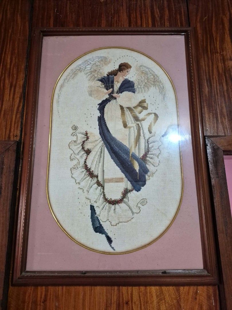 Framed Angel Cross-Stitch Artwork (Category: Frames & Pictures) located in Muntinlupa City. Submitted by googoosh_collection (Listing ID 1464609309, Image 2). Description: -Angel of Hope cross stitch with Frame -Exquisite framed cross-stitch artwork featuring a detailed angel. - Elegant wooden frame with a sophisticated gold inner trim. - Soft pink matting surrounds the beautiful stitching. - Comes ready to hang, perfect for adding charm to your 