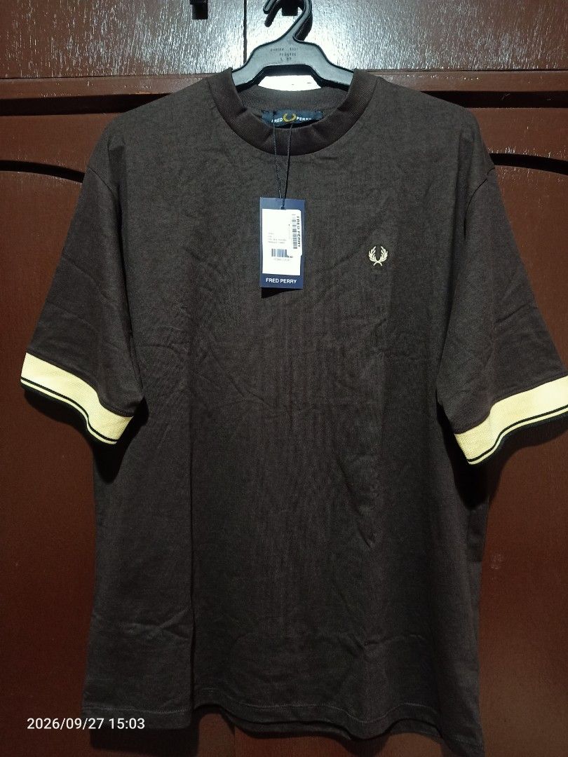 Fred Perry T-shirt Mens (Category: Tshirts & Polo Shirts ) located in Las Pinas. Submitted by OmengSoyT (Listing ID 1464721265, Image 3). Description: - Brand: Fred Perry - Color: Brown with yellow and dark trim on cuffs - Size: Medium (Standard fit) can fit to Large - 100% premium cotton fabric - Condition: Brand new with original store hang tag attached - Design: Short sleeves, crew neck collar, and signature embroidered laurel wreath logo on c