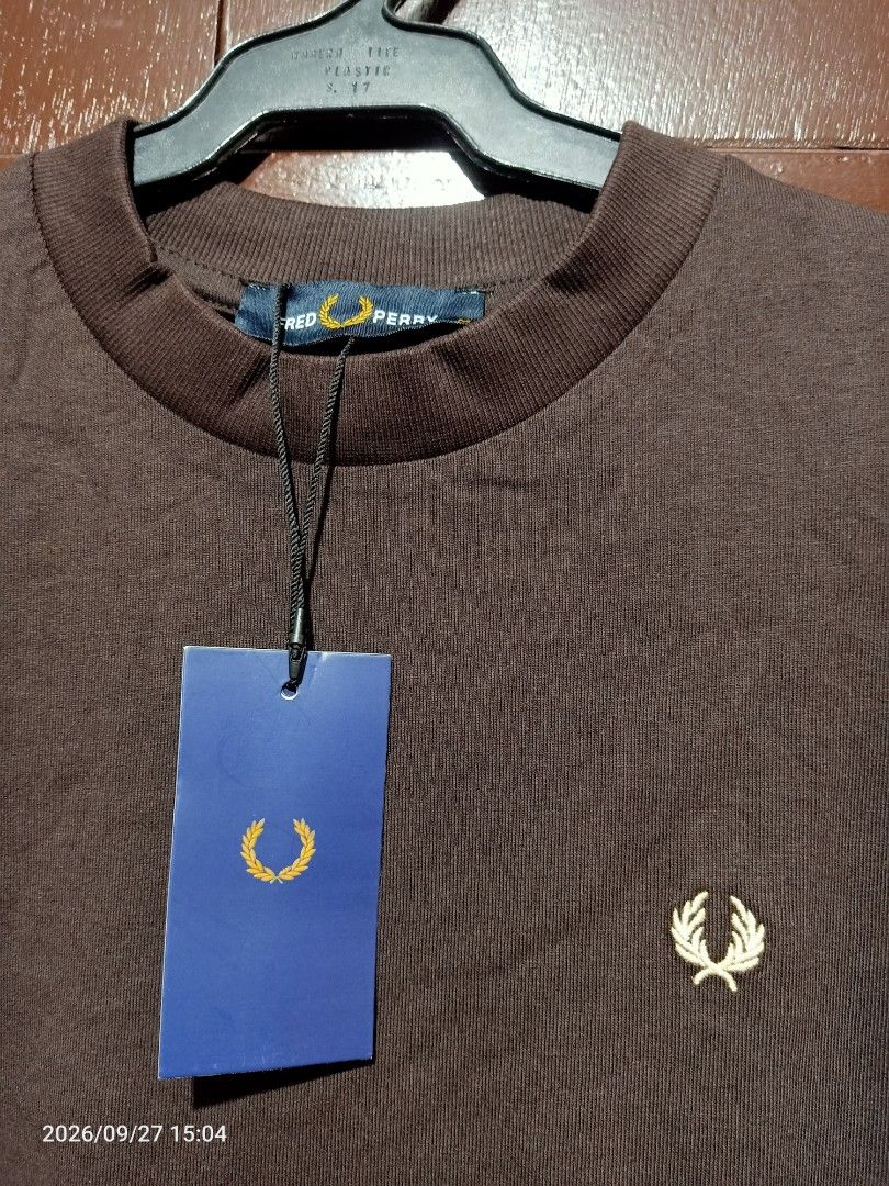 Fred Perry T-shirt Mens (Category: Tshirts & Polo Shirts ) located in Las Pinas. Submitted by OmengSoyT (Listing ID 1464721265, Image 1). Description: - Brand: Fred Perry - Color: Brown with yellow and dark trim on cuffs - Size: Medium (Standard fit) can fit to Large - 100% premium cotton fabric - Condition: Brand new with original store hang tag attached - Design: Short sleeves, crew neck collar, and signature embroidered laurel wreath logo on c