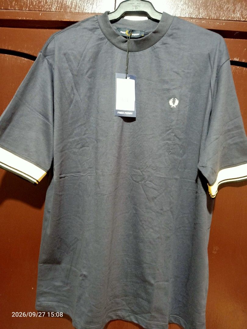 Fred Perry T-Shirt Mens (Category: Tshirts & Polo Shirts ) located in Las Pinas. Submitted by OmengSoyT (Listing ID 1464723396, Image 2). Description: - Brand: Fred Perry - Color: Dark Navy Blue - Size:(M) Medium (Standard size can fit to Large size) - Condition: Brand new with original hang tag - Details: Ribbed mock neck collar, yellow and black striped contrast cuffs, iconic embroidered laurel wreath logo on chest - Quality: Premium fabric wit