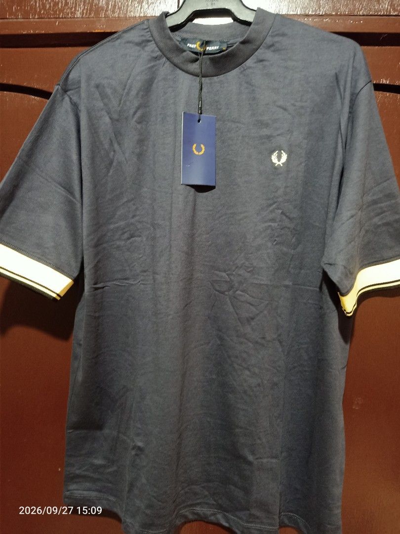 Fred Perry T-Shirt Mens (Category: Tshirts & Polo Shirts ) located in Las Pinas. Submitted by OmengSoyT (Listing ID 1464723396, Image 3). Description: - Brand: Fred Perry - Color: Dark Navy Blue - Size:(M) Medium (Standard size can fit to Large size) - Condition: Brand new with original hang tag - Details: Ribbed mock neck collar, yellow and black striped contrast cuffs, iconic embroidered laurel wreath logo on chest - Quality: Premium fabric wit