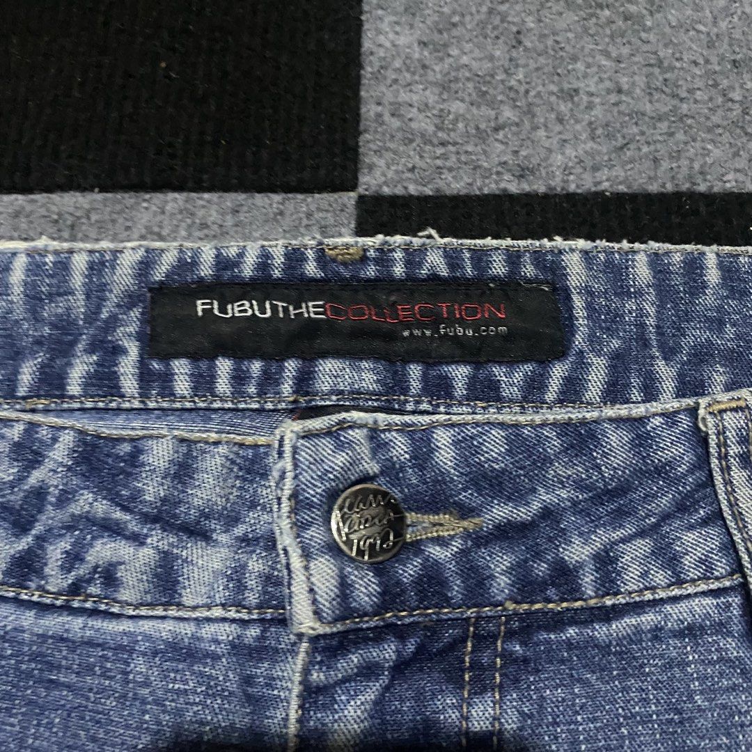 Fubu The Collection Denim Shorts (Category: Shorts) located in Manila. Submitted by gregmarc5503863 (Listing ID 1464752338, Image 3). Description: - Brand: Fubu (1992 era vintage) - Color/Wash: Washed blue - Style: Classic mid-length denim shorts (jorts) - Details: Contrast stitching, front embroidered Fubu logo graphic, branded back leather patch with metallic rivet - Closure: Button fly - Fit: Straight hem, comfortable streetwear essential FUBU