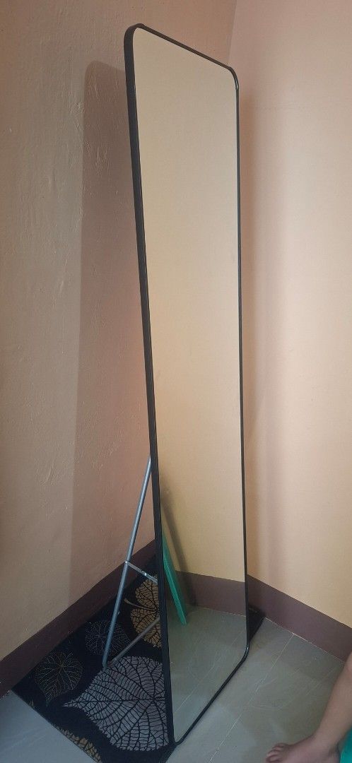 Full length standing mirror with metal frame (Category: Mirrors) located in Manila. Submitted by josemaradigue (Listing ID 1464766808, Image 1). Description: - Full-length rectangular mirror for a complete view of your outfit - Sleek and durable black metal frame - Built-in folding stand for easy floor placement - Sturdy legs ensure excellent balance and stability - Ideal for bedrooms, dressing areas, or getting ready spots.