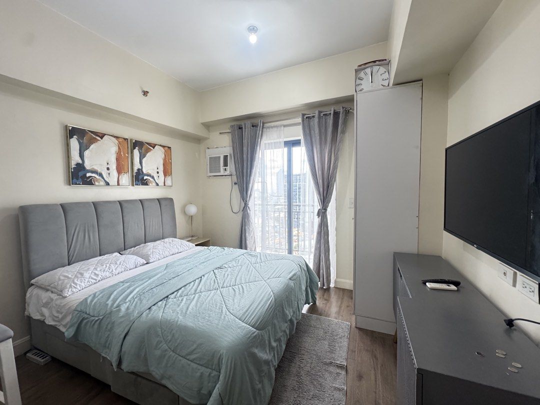 Fully Furnished Studio Condominium Unit for Rent (Category: Apartments & Condos) located in Cebu City. Submitted by rexvillar90852 (Listing ID 1464727272, Image 2). Description: - Fully furnished move-in ready studio unit - Sleeping & Living: Queen-sized bed, flat-screen TV, air conditioner, wardrobe cabinet - Dining & Kitchen: Dining table with stools, built-in cabinets, refrigerator, microwave, rice cooker, and sink - Bathroom: Private with sho