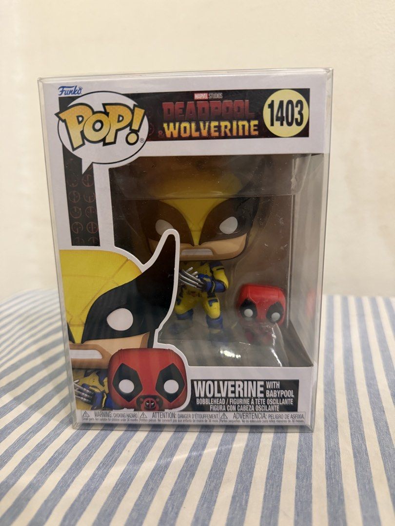 Funko Pop Marvel Wolverine with Babypool 1403 (Category: Figurines & Statues) located in Davao. Submitted by hungryapple_469 (Listing ID 1464620022, Image 1). Description: - Marvel Studios Deadpool & Wolverine Funko Pop! Vinyl Figure - Figure Number: 1403 - Features Wolverine with Baby Deadpool - Comes in its original, unopened box.