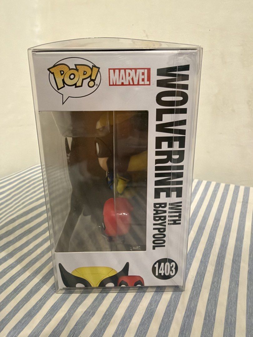 Funko Pop Marvel Wolverine with Babypool 1403 (Category: Figurines & Statues) located in Davao. Submitted by hungryapple_469 (Listing ID 1464620022, Image 2). Description: - Marvel Studios Deadpool & Wolverine Funko Pop! Vinyl Figure - Figure Number: 1403 - Features Wolverine with Baby Deadpool - Comes in its original, unopened box.