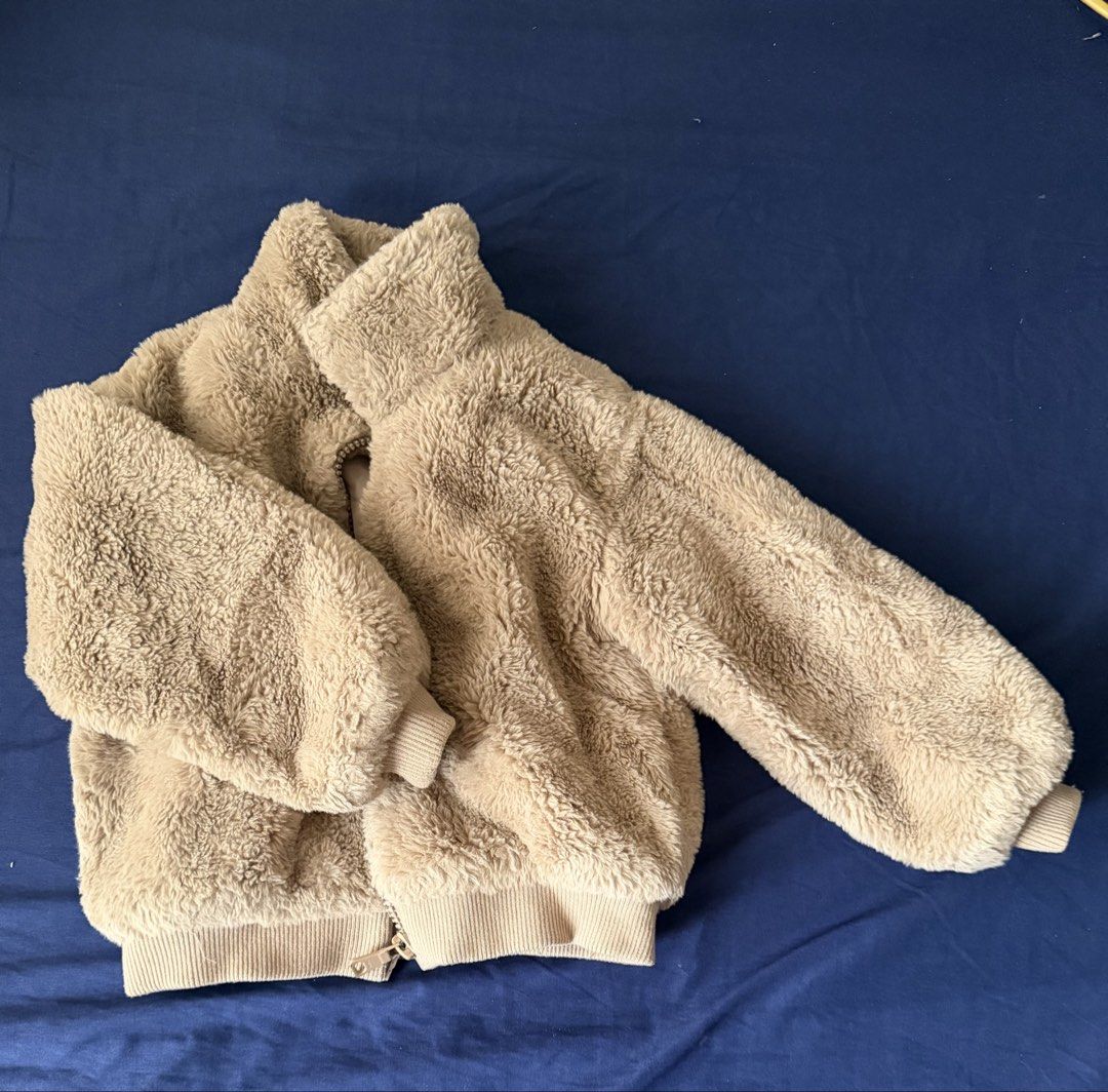 Fuzzy Fleece Zip-Up Jacket (Category: Babies & Kids Fashion) located in Quezon City. Submitted by momdecluttering (Listing ID 1464585988, Image 1). Description: - Super soft and cozy fuzzy fleece jacket - Zip-up front for easy wear - Ribbed cuffs and hem for a snug fit - Neutral beige color, easy to style - Ideal for layering on cooler days - Looks warm and comfortable.