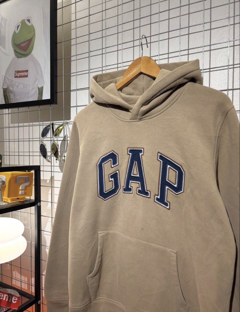 GAP Hoodie Tan Blue Logo Pullover Sweatshirt (Category: Coats, Jackets and Outerwear) located in Cavite. Submitted by vlblgrmnts_ (Listing ID 1464644591, Image 2). Description: - Classic tan GAP hoodie - Iconic blue embroidered GAP logo on front - Front pouch pocket - Drawstring hood - Soft and comfortable material - Perfect for casual, everyday styling 23x27 Best fit large 900.