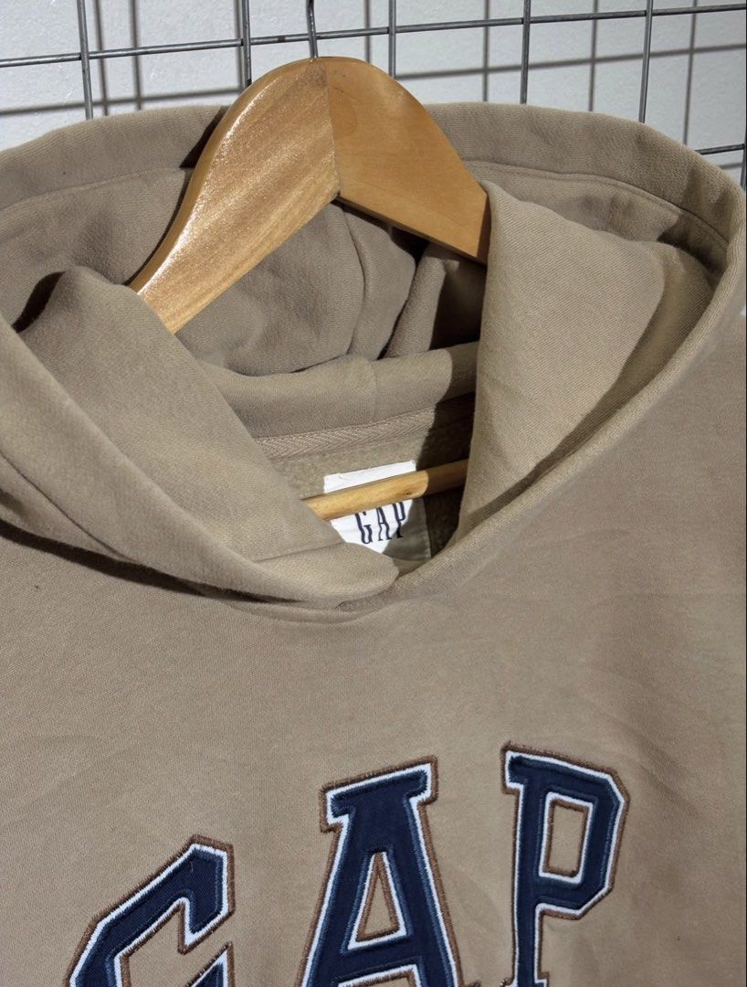 GAP Hoodie Tan Blue Logo Pullover Sweatshirt (Category: Coats, Jackets and Outerwear) located in Cavite. Submitted by vlblgrmnts_ (Listing ID 1464644591, Image 3). Description: - Classic tan GAP hoodie - Iconic blue embroidered GAP logo on front - Front pouch pocket - Drawstring hood - Soft and comfortable material - Perfect for casual, everyday styling 23x27 Best fit large 900.