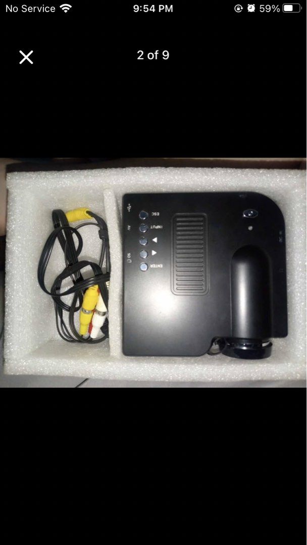 GEEKWIRE LED Projector with AV cables (Category: Projectors) located in Manila. Submitted by yegoo751 (Listing ID 1464721435, Image 2). Description: - Brand: GEEKWIRE entry-level LED projector - Color: Sleek black with compact, space-saving design - Inclusions: Original box, AV to 3.5mm cable, and extra adapters (as seen in photos) - Features: Top-mounted control buttons and manual focus lens - Best For: Budget-friendly home movie nights and casu