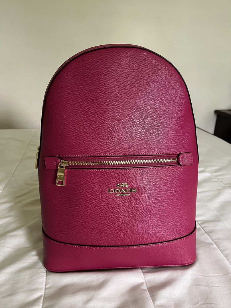 Genuine COACH Kenley Cross Grain Leather Bright Violet Backpack (Category: Backpacks) located in Mabalacat. Submitted by fourthoct (Listing ID 1464596811, Image 1). Description: ⭐️ Measurements are 10”wide, 13”2 high, 5” deep and two 32” back straps each. One main compartment with a back zipper pocket, two back pockets, top handle and a top zipper closure. This backpack is in excellent condition, well cared for, hang tag, exterior pocket for easy