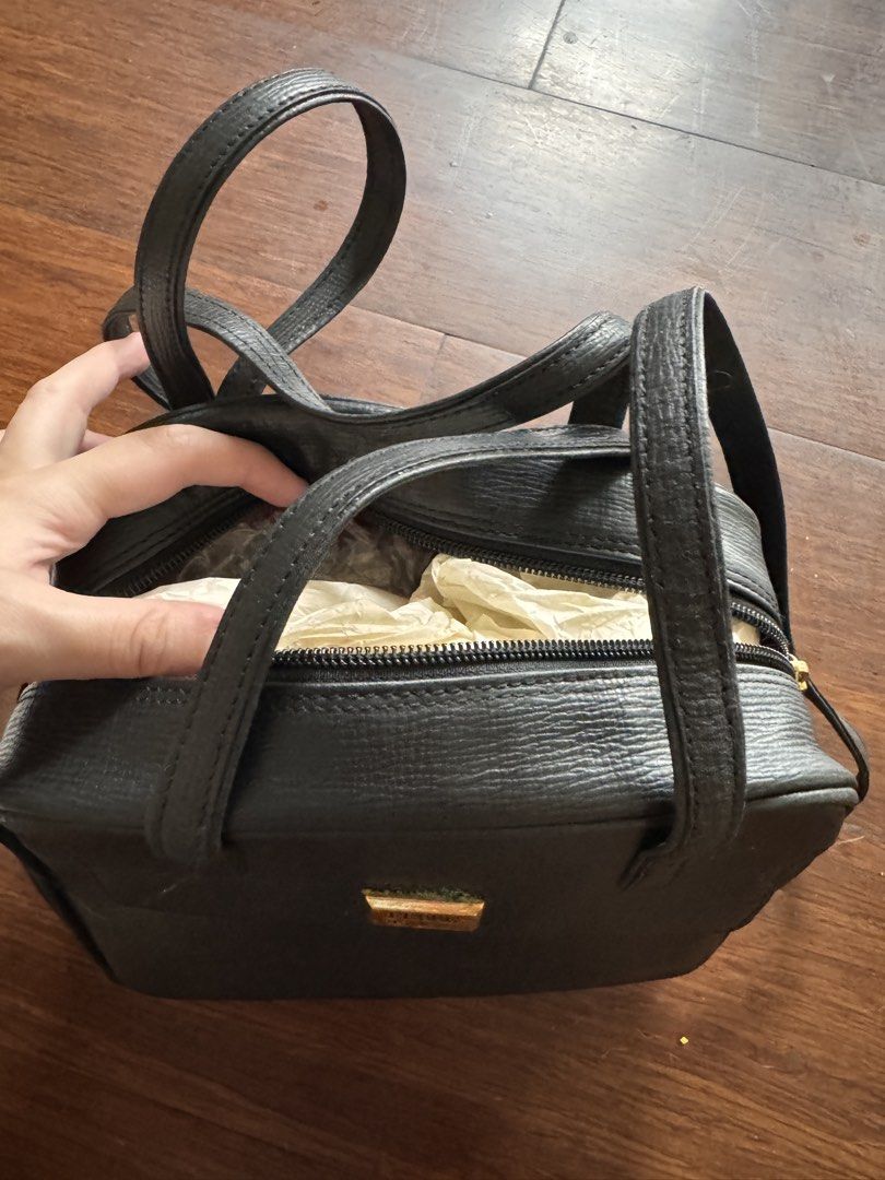 Gianfranco Ferre Black Leather Handbag (Category: Luxury Bags & Wallets) located in Quezon City. Submitted by wilstockpile (Listing ID 1464579761, Image 2). Description: - Authentic Gianfranco Ferre black leather handbag - Textured leather finish for a sophisticated look - Versatile wear: comfortable top handles and a longer shoulder strap - Secure zipper closure to keep your belongings safe - Comes with the original dust bag for storage - A time