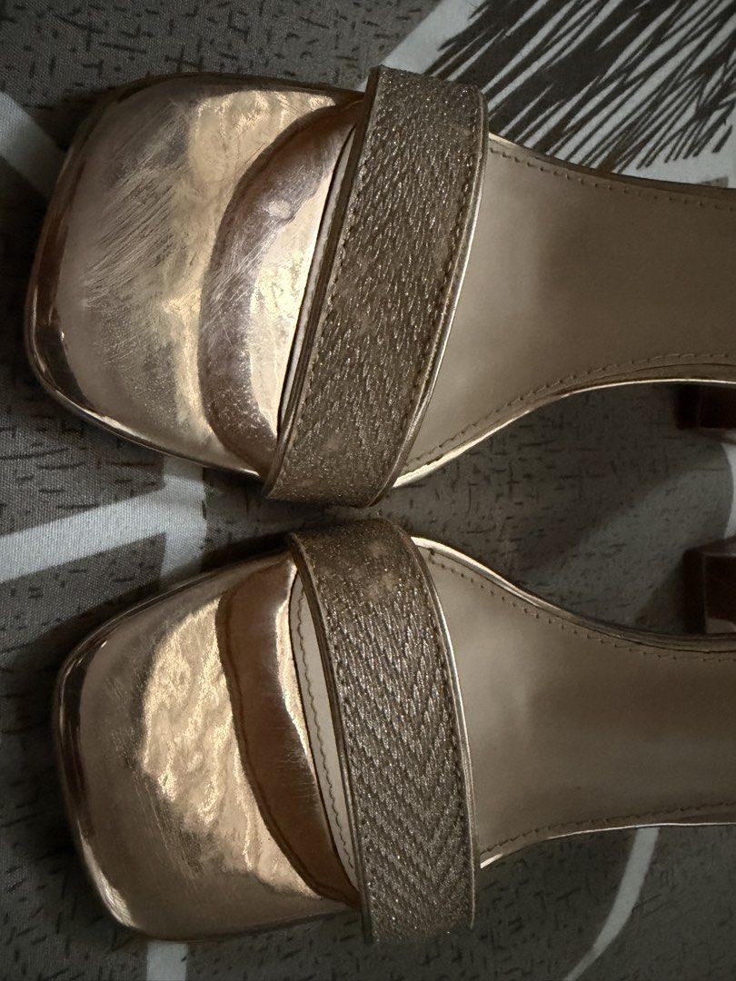 GIBI Rose Gold Block Heels Sandals Size 38 (Category: Heels) located in Tarlac. Submitted by ney14 (Listing ID 1464653903, Image 2). Description: Rose gold block heels from GIBI. Style name is QUINCE. Features an ankle strap and a sparkly band across the toes. The heel is a chunky block style. Size 38. Some scuff marks on the front and soles from wear. Great for dressing up..