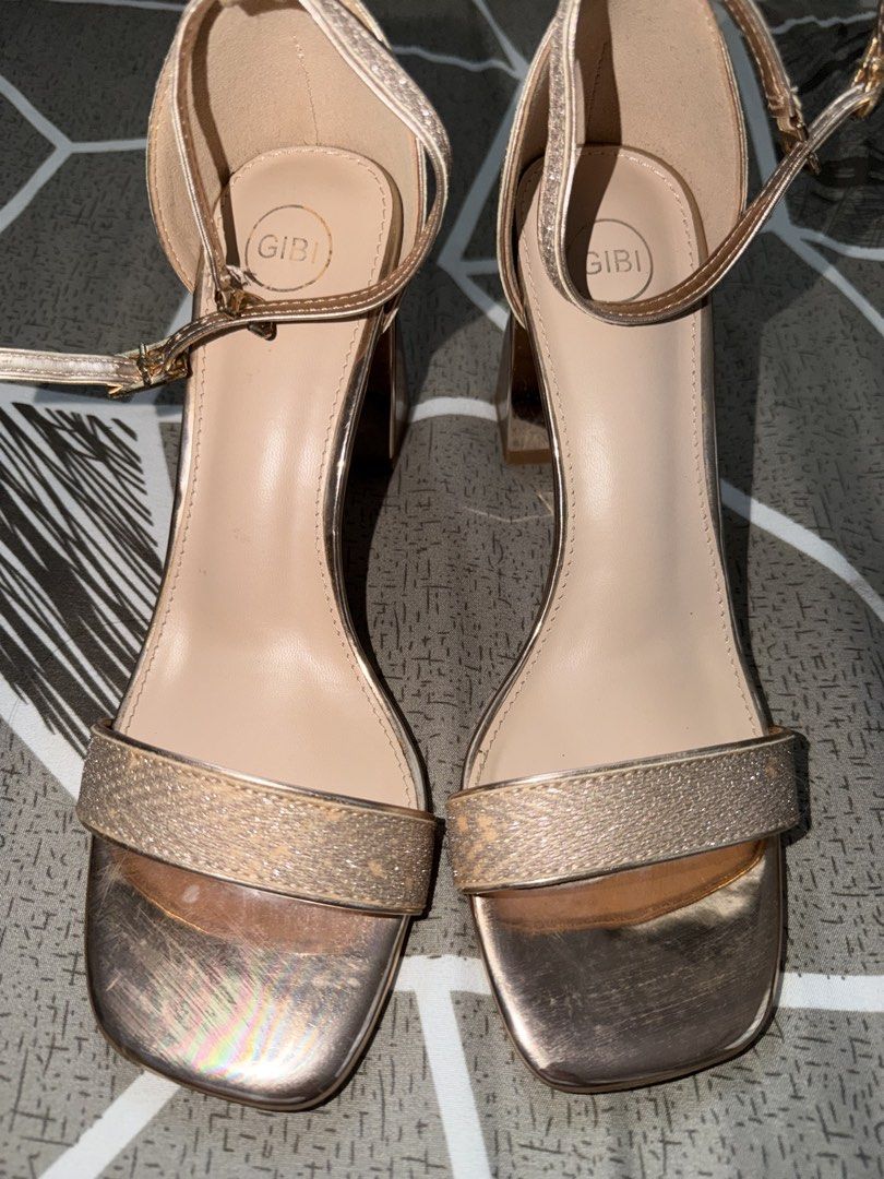 GIBI Rose Gold Block Heels Sandals Size 38 (Category: Heels) located in Tarlac. Submitted by ney14 (Listing ID 1464653903, Image 1). Description: Rose gold block heels from GIBI. Style name is QUINCE. Features an ankle strap and a sparkly band across the toes. The heel is a chunky block style. Size 38. Some scuff marks on the front and soles from wear. Great for dressing up..