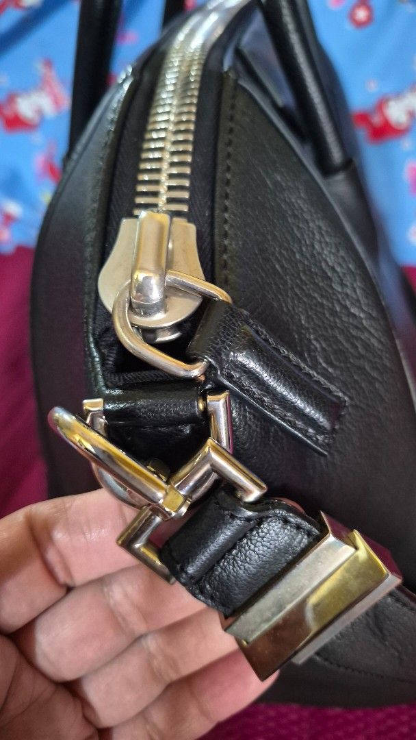 Givenchy Black Leather Handbag (Category: Luxury Bags & Wallets) located in Baguio. Submitted by jhaz_bags (Listing ID 1464708177, Image 2). Description: - Brand: Givenchy - Material: Premium black textured leather - Hardware: Silver-tone - Straps: Dual top handles with a detachable shoulder strap - Closure: Top zipper closure - Details: Structured base with protective leather feet and front logo stamp - Condition: Excellent/Worn with care - Meet