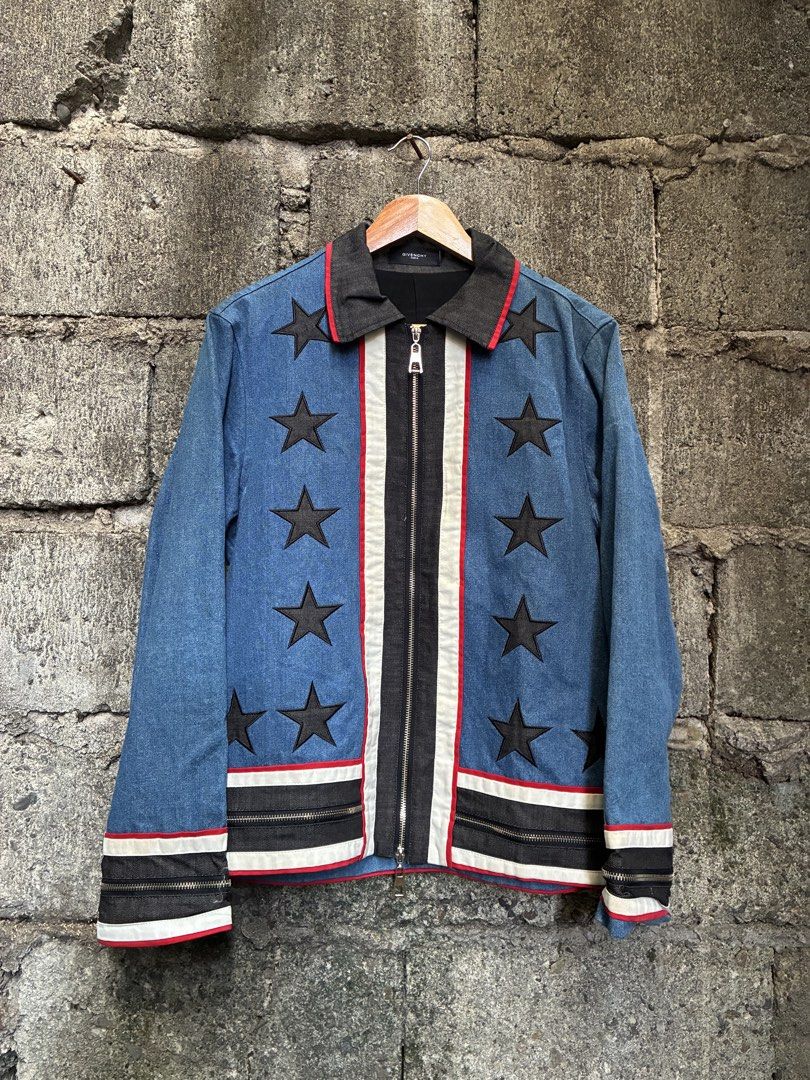 Givenchy Star Print Denim Jacket Runway Piece (Category: Coats, Jackets and Outerwear) located in Manila. Submitted by assortedgoodsv3 (Listing ID 1464764747, Image 2). Description: - Givenchy runway collection denim jacket - Blue wash denim body with standout black star appliques - Contrasting front/hem striped panels and edgy zipper details on cuffs and waist - Premium heavyweight fabric with dark collar and interior lining - Secure metal zip c