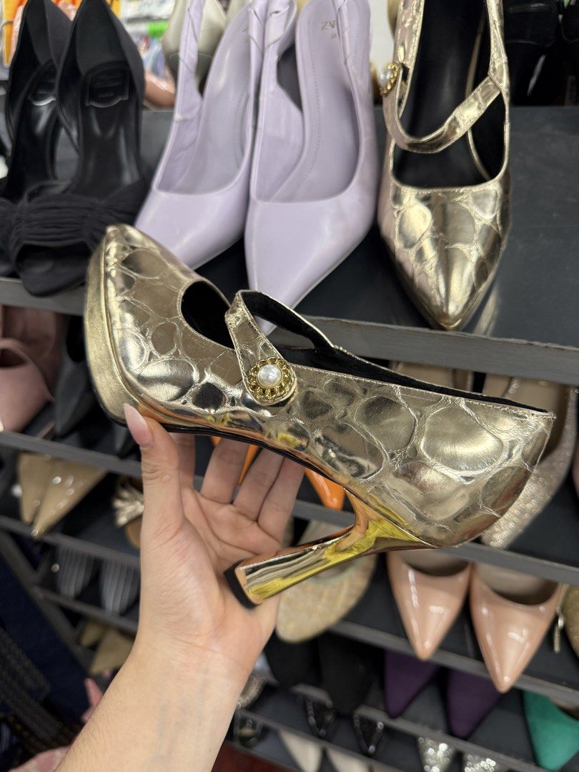 Gold Metallic Mary Jane Pumps with Pearl Strap Button (Category: Heels) located in Manila. Submitted by fastlion.584bdf (Listing ID 1464737862, Image 1). Description: Gold metallic heels with an embossed pattern across the upper. Mary Jane strap featuring a decorative button with a central pearl accent. Pointed toe design and high block heel with a shiny metallic finish. Sole shows standard size marking of 240(1.5)..