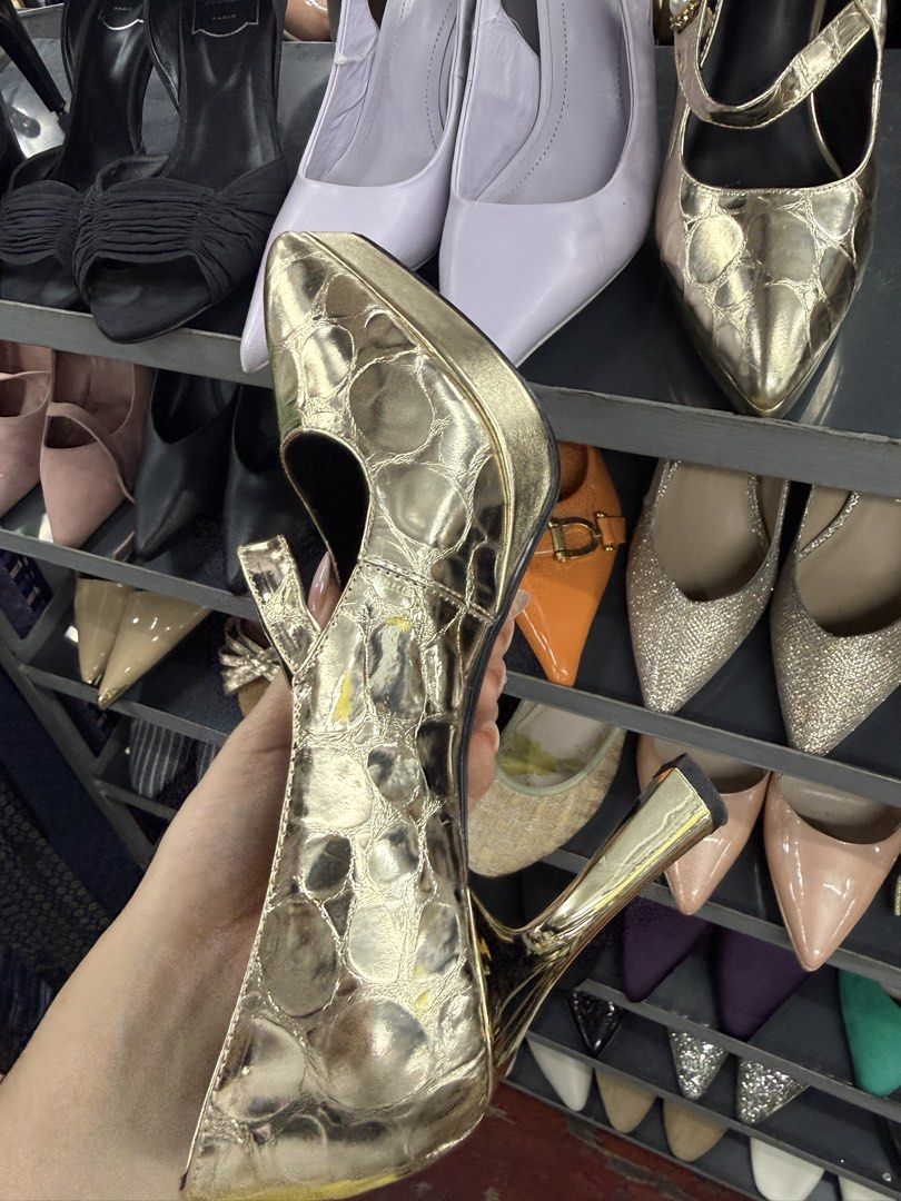 Gold Metallic Mary Jane Pumps with Pearl Strap Button (Category: Heels) located in Manila. Submitted by fastlion.584bdf (Listing ID 1464737862, Image 3). Description: Gold metallic heels with an embossed pattern across the upper. Mary Jane strap featuring a decorative button with a central pearl accent. Pointed toe design and high block heel with a shiny metallic finish. Sole shows standard size marking of 240(1.5)..