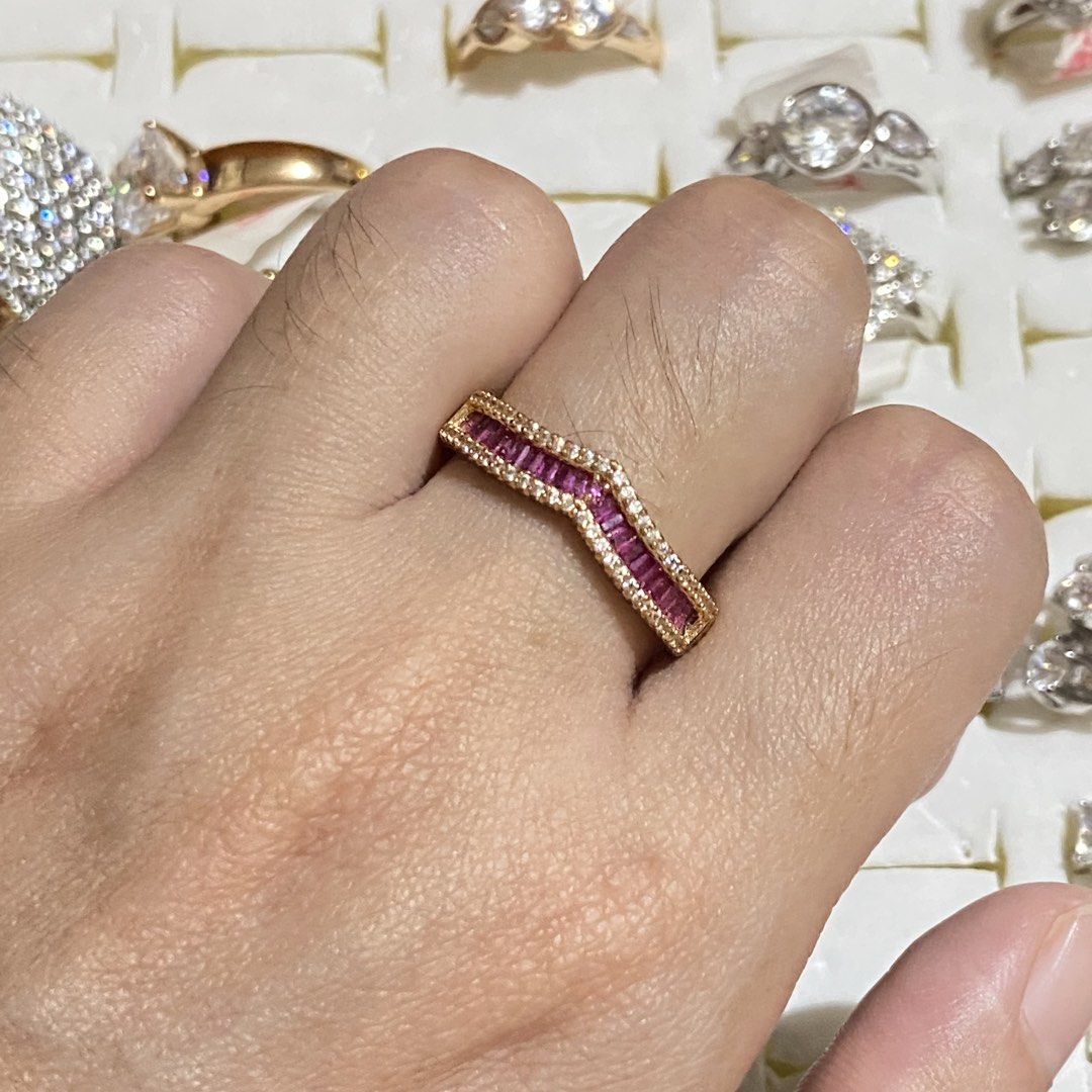 Gold Ring with Red and White Stones (Category: Rings) located in Davao. Submitted by alessuh (Listing ID 1464642963, Image 1). Description: - Elegant gold ring with a stylish chevron design. - Features a beautiful combination of small red and clear stones. - Estimated size: 6 or 7. - Versatile for stacking with other rings or wearing as a standalone statement piece. - Offers a lovely sparkle..
