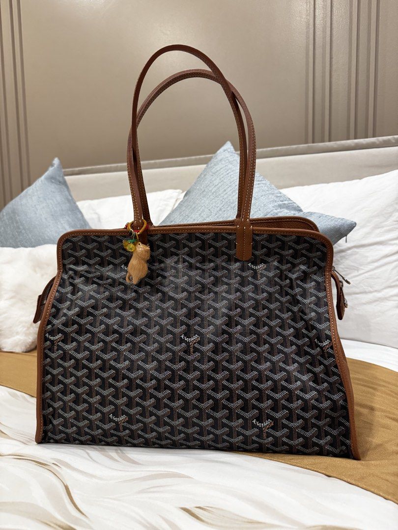 Goyard Sac Hardy Tote Bag (Category: Luxury Bags & Wallets) located in Manila. Submitted by love_preloveddd (Listing ID 1464666979, Image 1). Description: - Classic Goyard tote bag - Signature all-over print - Brown leather trim and handles - Adorable charm attached to handle - Spacious interior for all your essentials - Ideal for everyday use.