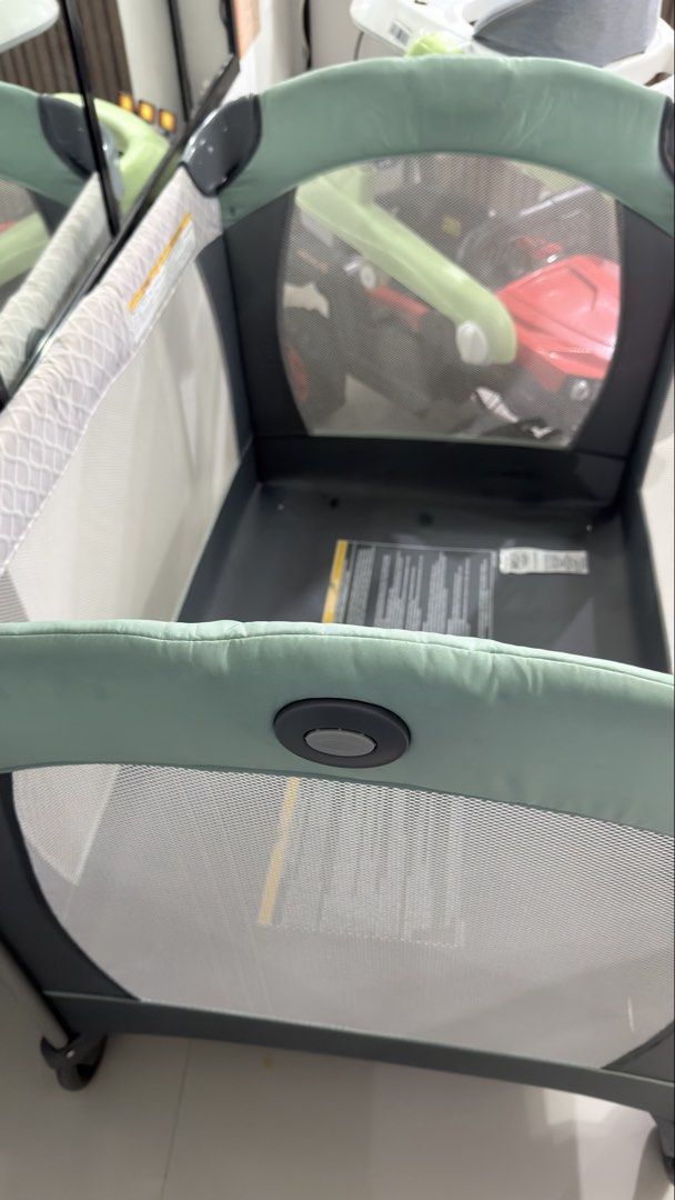Graco Pack 'n Play Playard (Category: Cots & Cribs) located in Cavite. Submitted by fashyph (Listing ID 1464756109, Image 2). Description: Graco Pack 'n Play playard in grey and sage green. Includes the folding mattress pad with warning labels and safety straps attached. Mesh sides for breathability and wheels on one side for easy moving around the room. Packs down simply for travel or storage. Unused, infant cot Issue: water marks from washing o