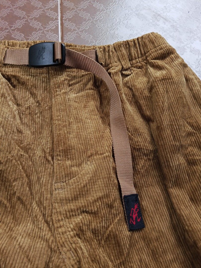 Gramicci Corduroy Pants (Category: Trousers) located in Davao. Submitted by carnopaul76938 (Listing ID 1464709319, Image 3). Description: - Brand: Gramicci - Color: Rich camel brown - Material: Textured corduroy rib fabric for warmth - Fit: Classic relaxed fit with elastic waistband - Features: Built-in adjustable nylon webbing belt with quick-release buckle and running man logo - Pockets: Dual rear welt pockets with branded woven label - Style: 