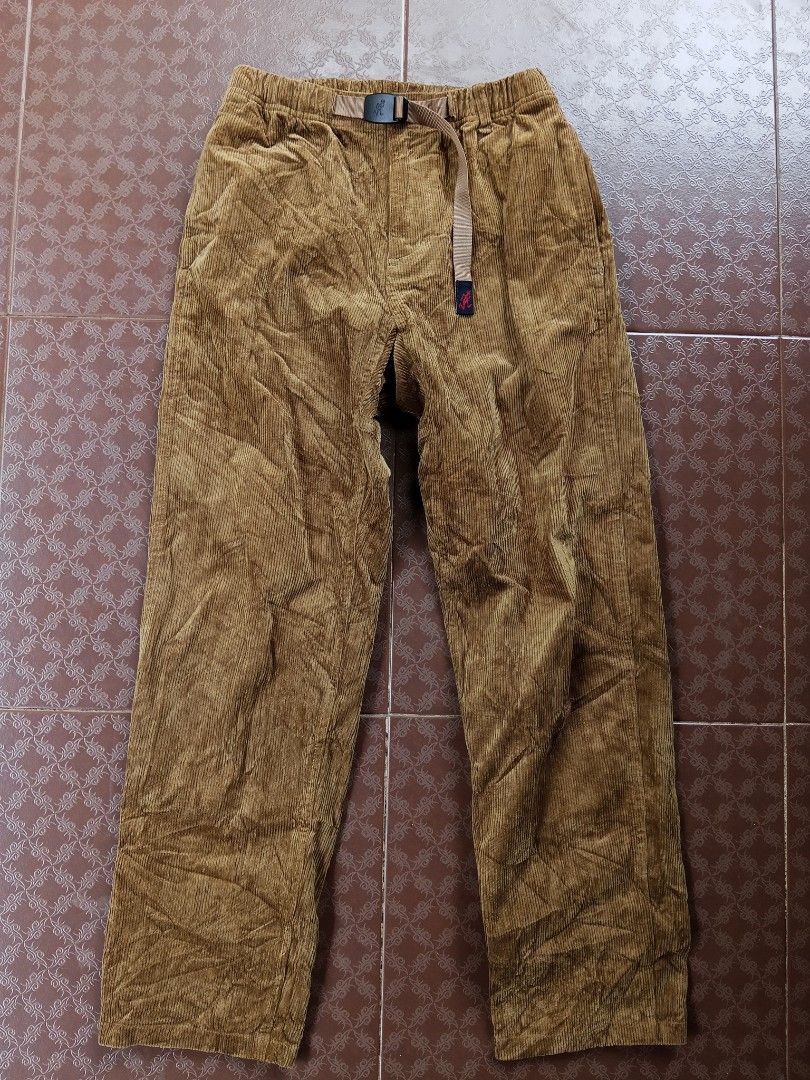 Gramicci Corduroy Pants (Category: Trousers) located in Davao. Submitted by carnopaul76938 (Listing ID 1464709319, Image 1). Description: - Brand: Gramicci - Color: Rich camel brown - Material: Textured corduroy rib fabric for warmth - Fit: Classic relaxed fit with elastic waistband - Features: Built-in adjustable nylon webbing belt with quick-release buckle and running man logo - Pockets: Dual rear welt pockets with branded woven label - Style: 