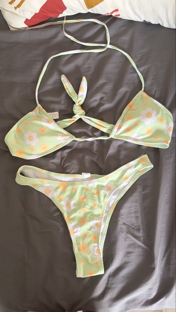 Green Daisy Print Bikini Set Size L (Category: Bikinis & Swimsuits) located in Bacoor. Submitted by trosee12 (Listing ID 1464633277, Image 2). Description: - Adorable green bikini with a charming daisy print. - Features a flattering halter neck top with adjustable ties. - Comes with a matching bikini bottom. - Crafted from a comfortable blend of polyester and spandex. - Ideal for your next beach getaway or pool party! USED ONLY ONCE.