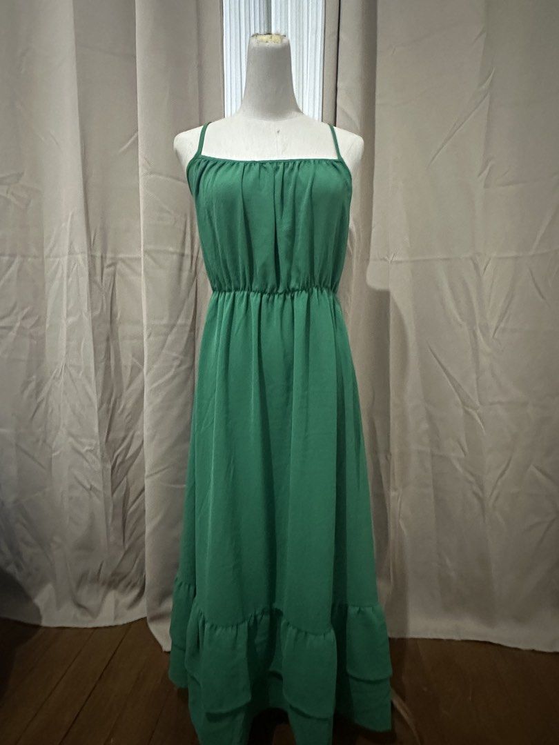 Green Spaghetti Strap Maxi Dress with Ruffle Hem (Category: Dresses) located in Taguig. Submitted by kokombeer (Listing ID 1464685174, Image 1). Description: - Flowy green maxi dress - Square neckline with spaghetti straps - Comfortable elasticated waist - Tiered ruffle hem for added detail - Ideal for casual outings or beach days - Easy to wear and style.