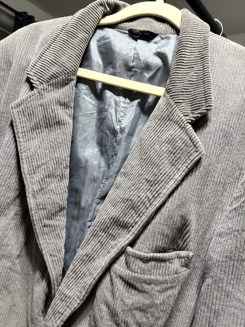 Grey Corduroy Blazer Jacket (Category: Coats, Jackets and Outerwear) located in Manila. Submitted by finderskeepersmnl_092026 (Listing ID 1464744958, Image 2). Description: - Style: Classic fit grey corduroy blazer - Design: Notched lapels and front button closure - Lining: Fully lined with matching grey fabric - Pockets: One chest pocket and two front flap pockets - Details: Structured shoulders for a sharp silhouette - Best for: Cooler weather 