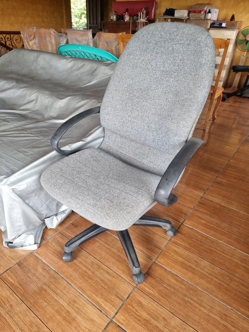 Grey Fabric Office Chair with Armrests (Category: Office Furniture & Fixtures) located in Quezon City. Submitted by rl_minimalist (Listing ID 1464615649, Image 2). Description: - Grey fabric office chair - Comfortable armrests - Swivels and rolls easily - Ideal for home or office - Minor fabric wear, fully functional.