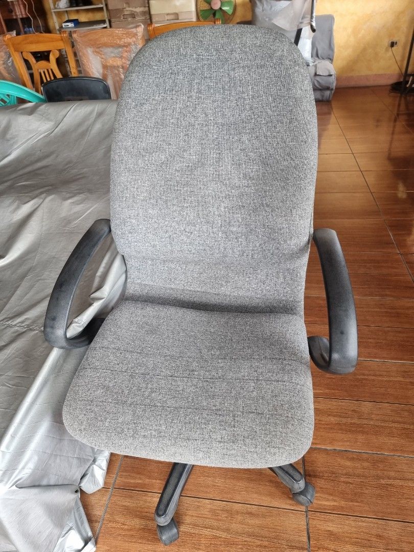 Grey Fabric Office Chair with Armrests (Category: Office Furniture & Fixtures) located in Quezon City. Submitted by rl_minimalist (Listing ID 1464615649, Image 1). Description: - Grey fabric office chair - Comfortable armrests - Swivels and rolls easily - Ideal for home or office - Minor fabric wear, fully functional.